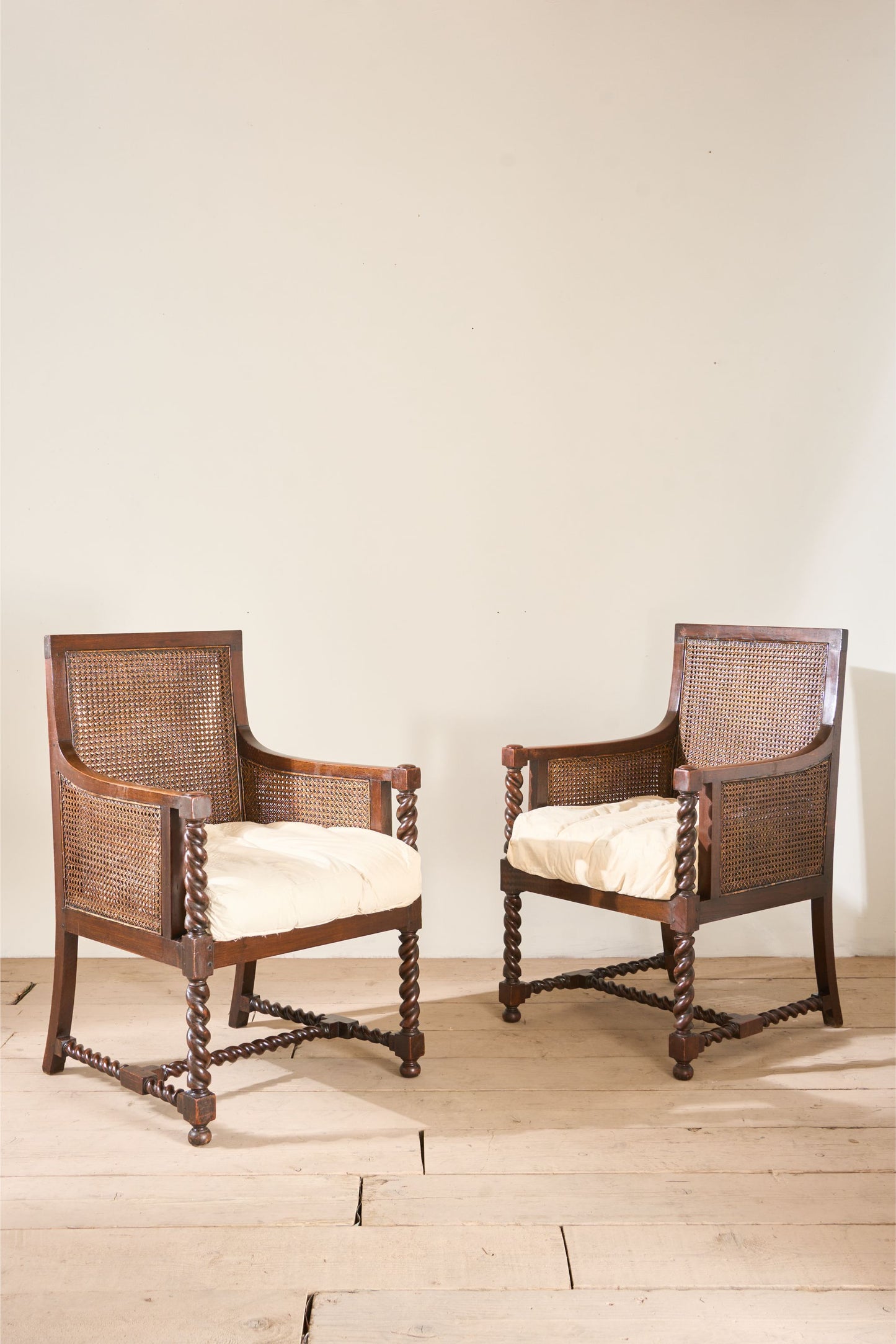 Pair of c.1920 barley twist mahogany rattan lounge chairs