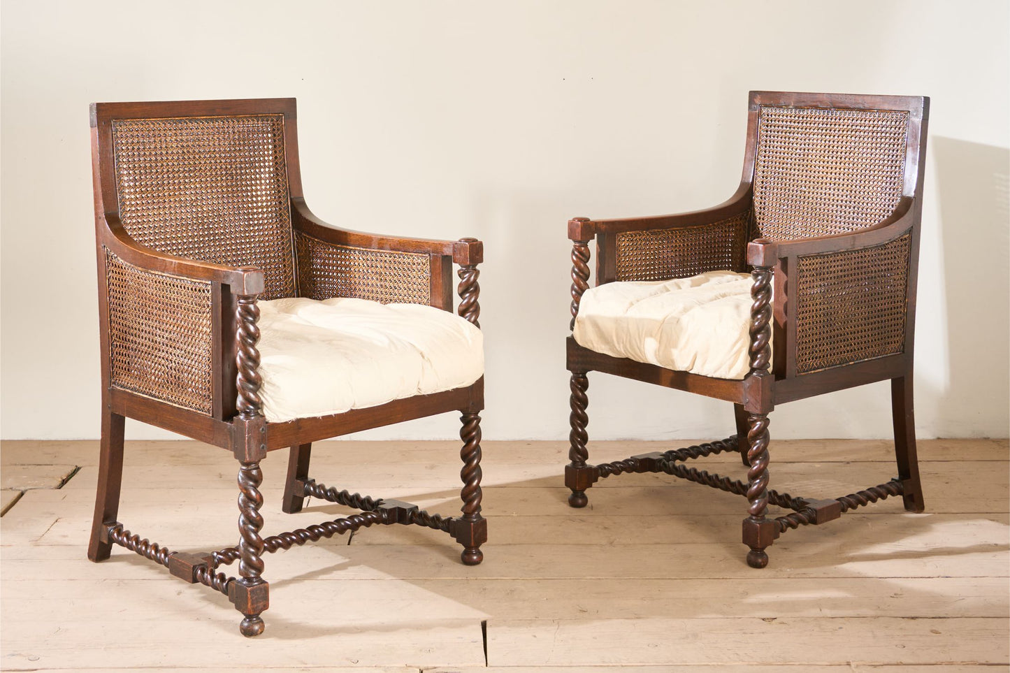 Pair of c.1920 barley twist mahogany rattan lounge chairs