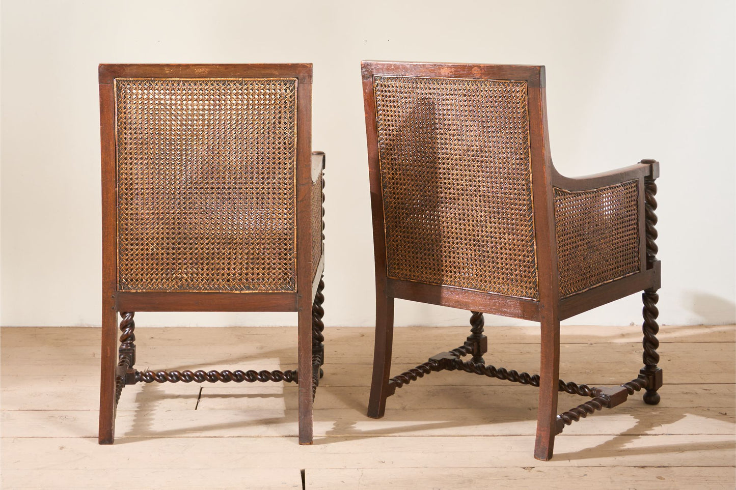Pair of c.1920 barley twist mahogany rattan lounge chairs