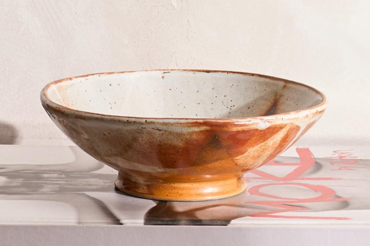 Vintage studio pottery bowl with orange decoration