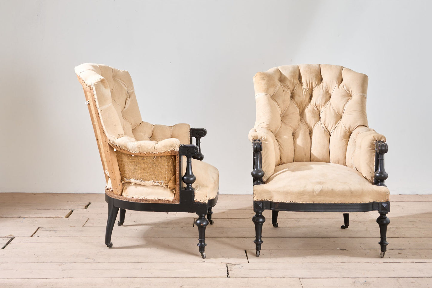 Pair of Napoleon III large buttoned shield back armchairs