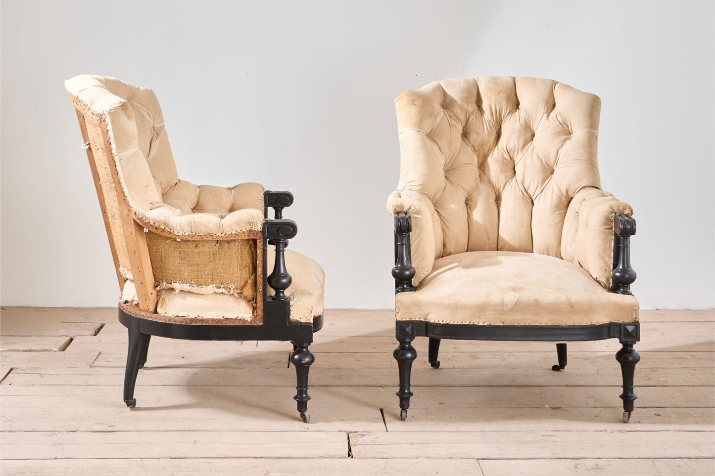 Pair of Napoleon III large buttoned shield back armchairs