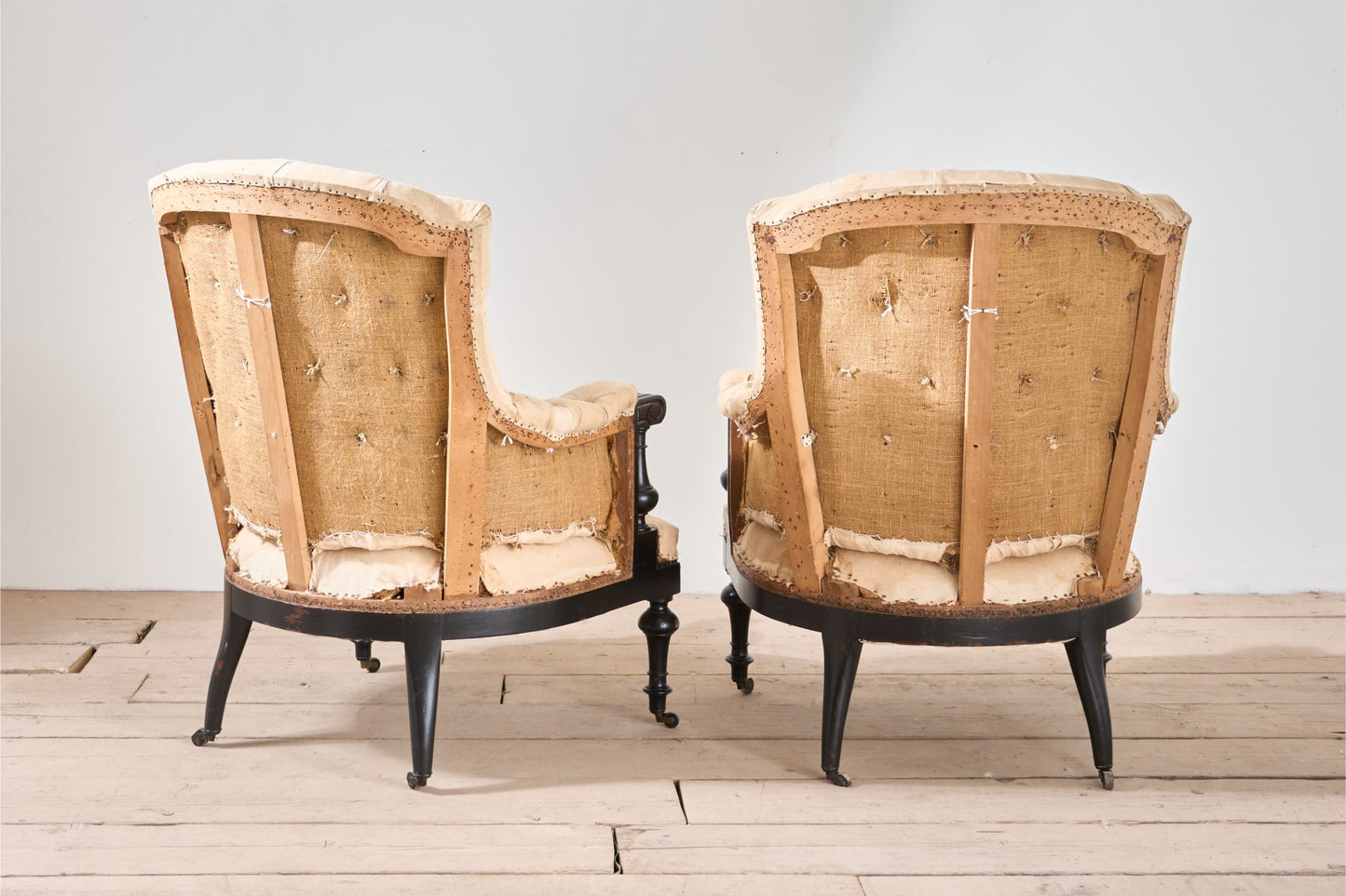 Pair of Napoleon III large buttoned shield back armchairs
