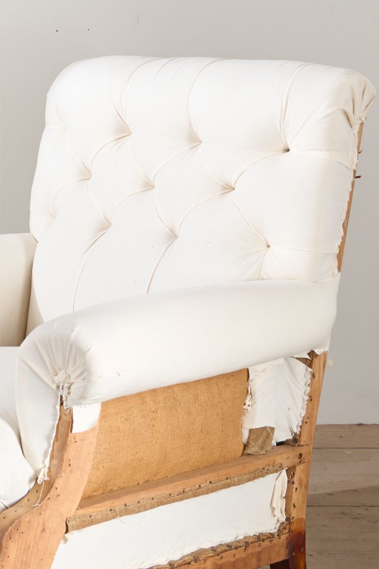 Large proportioned 19th century buttoned back armchair by Hamptons and sons