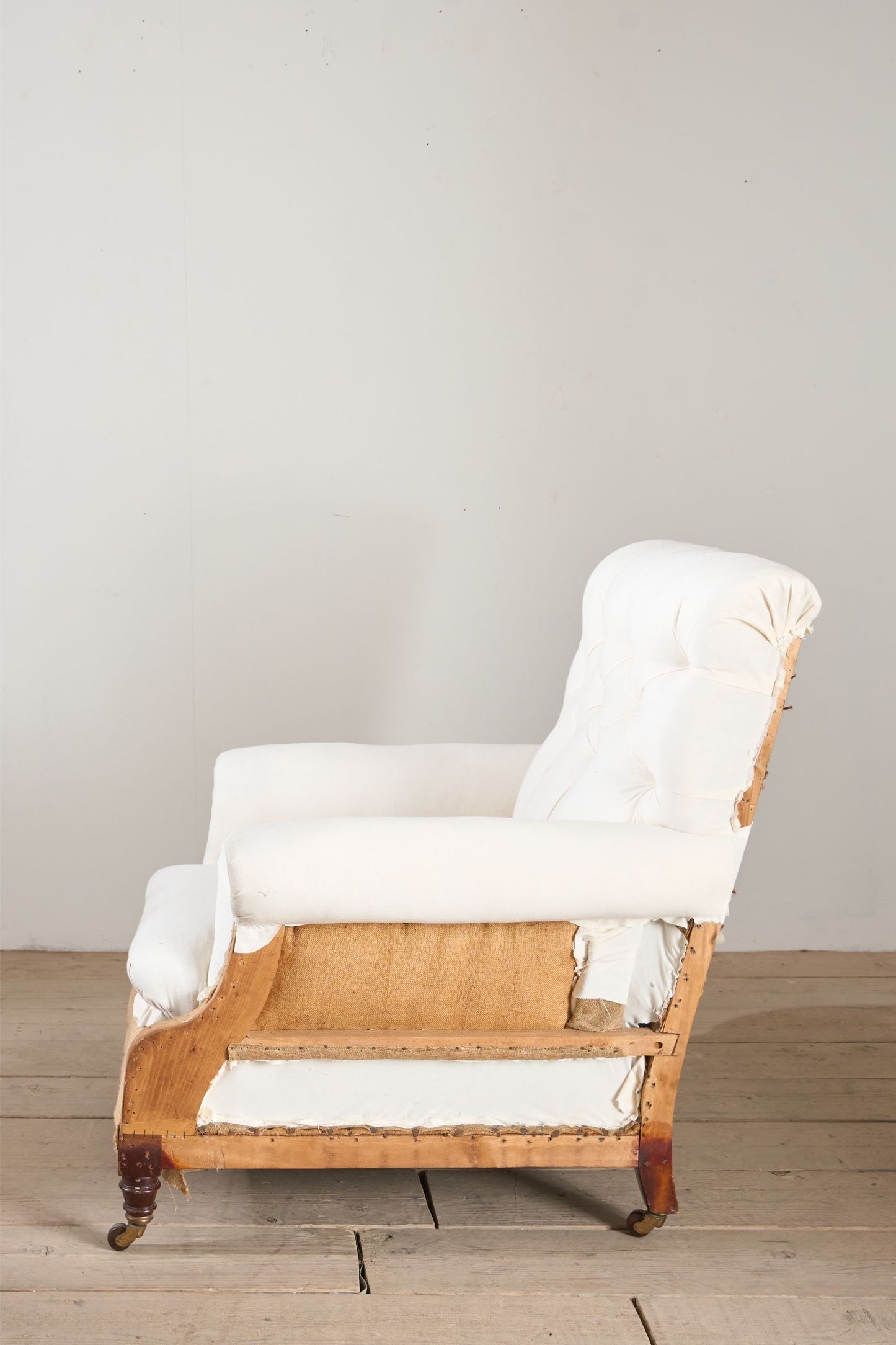 Large proportioned 19th century buttoned back armchair by Hamptons and sons