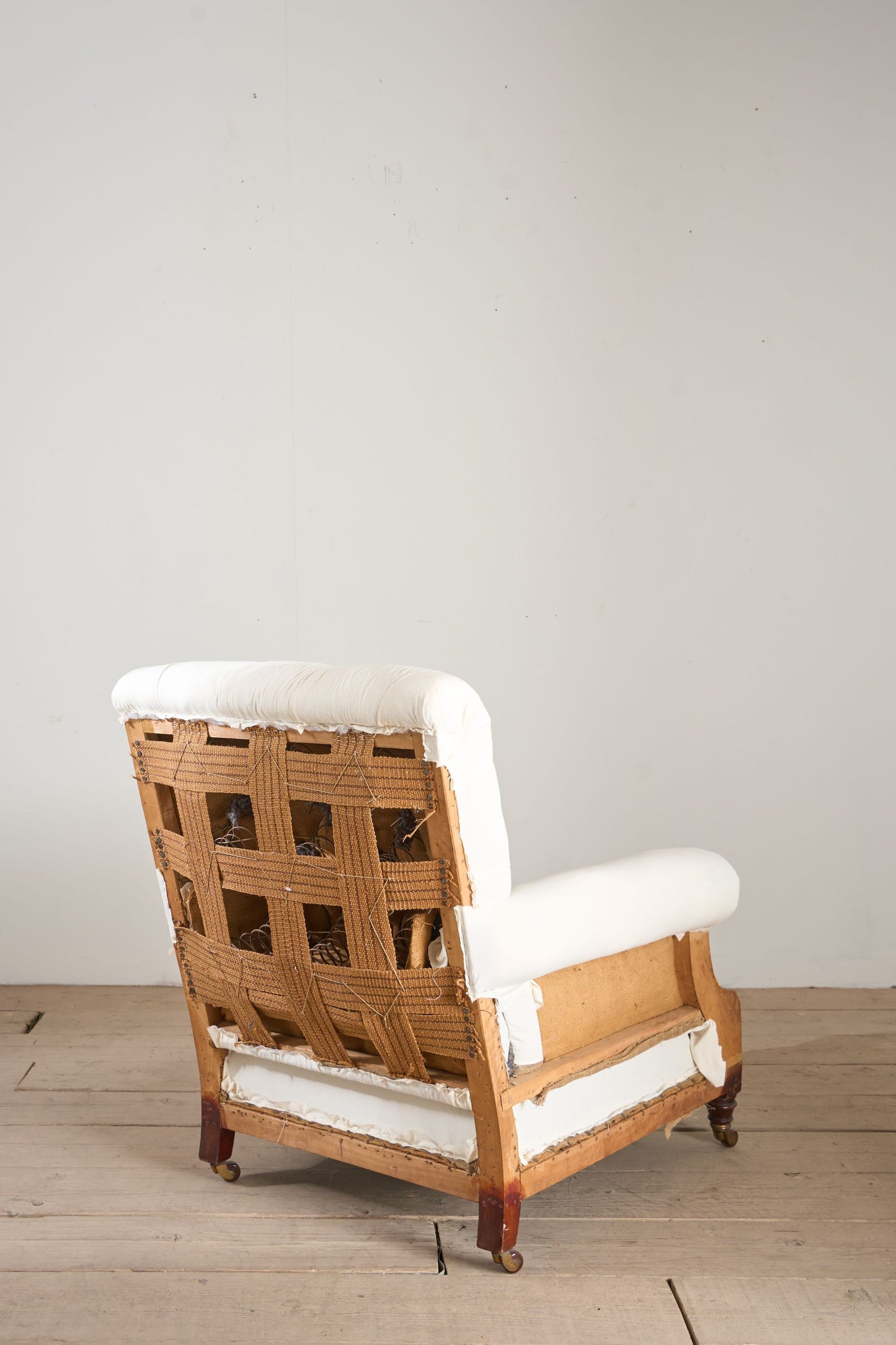 Large proportioned 19th century buttoned back armchair by Hamptons and sons