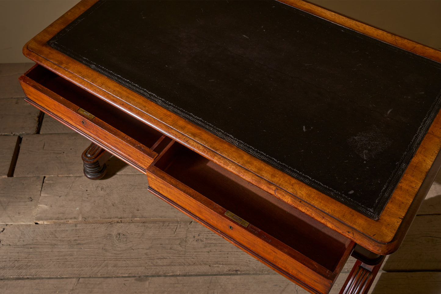 Early Victorian mahogany and black leather writing table by Johnstone & Jeanes