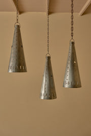 Trio of 20th century patinated steel and copper rivet conical pendant lights