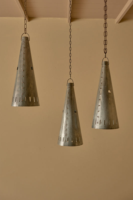 Trio of 20th century patinated steel and copper rivet conical pendant lights - TallBoy Interiors