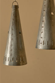Trio of 20th century patinated steel and copper rivet conical pendant lights