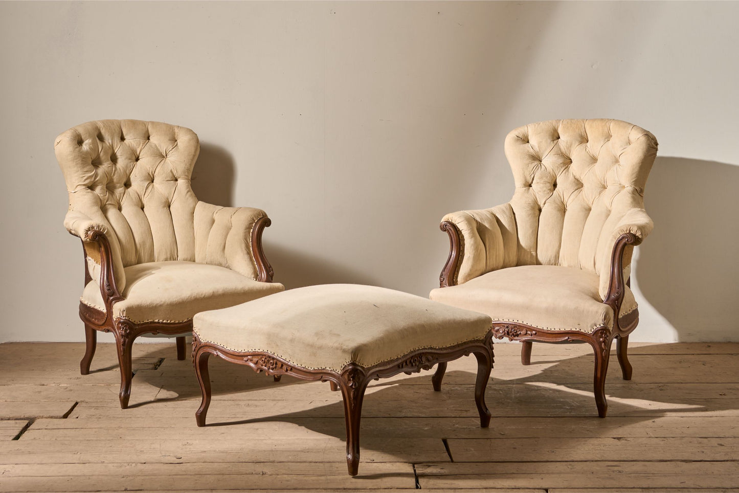 Pair of 19th Century buttoned back armchairs with matching stool