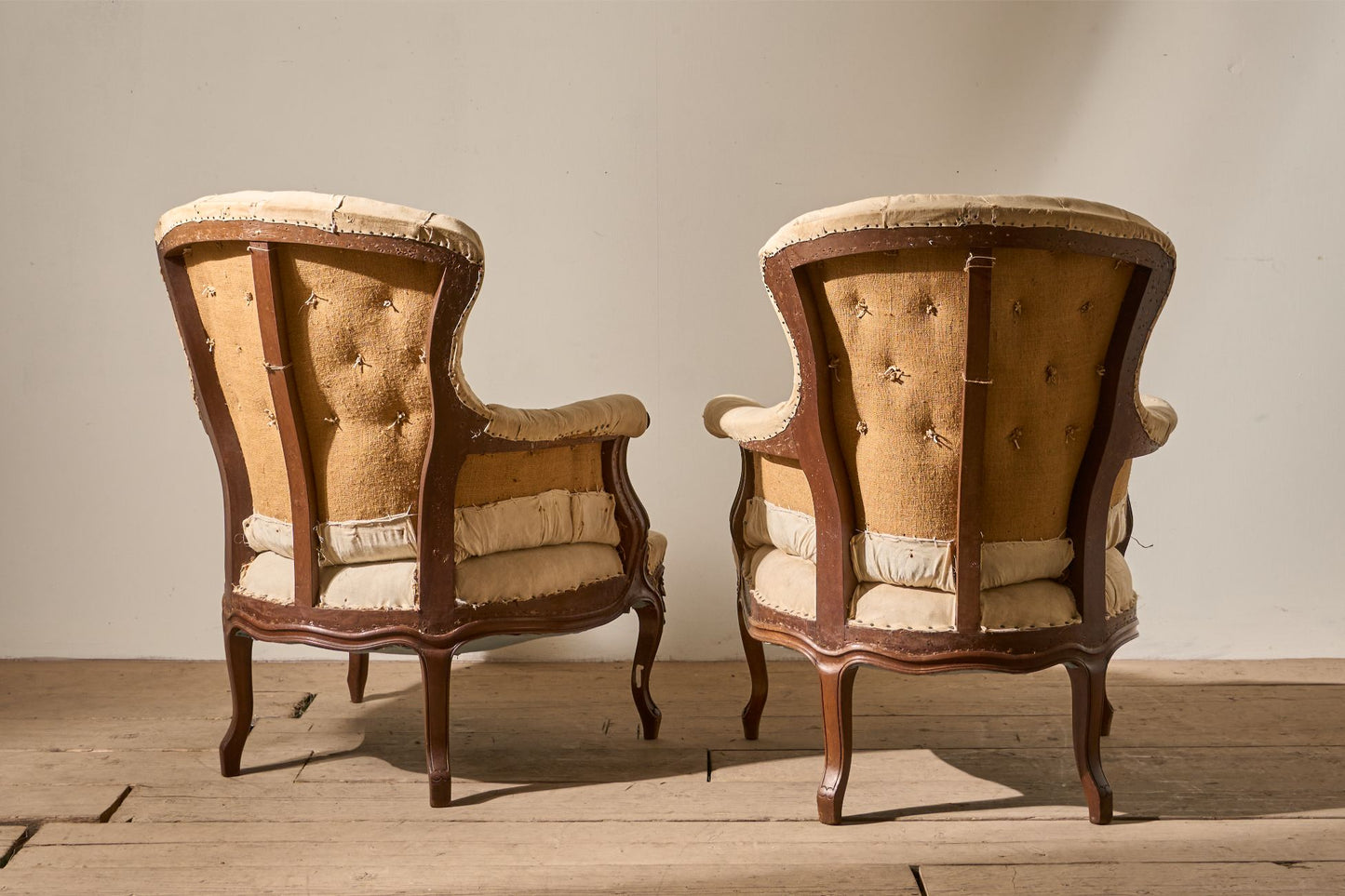 Pair of 19th Century buttoned back armchairs with matching stool