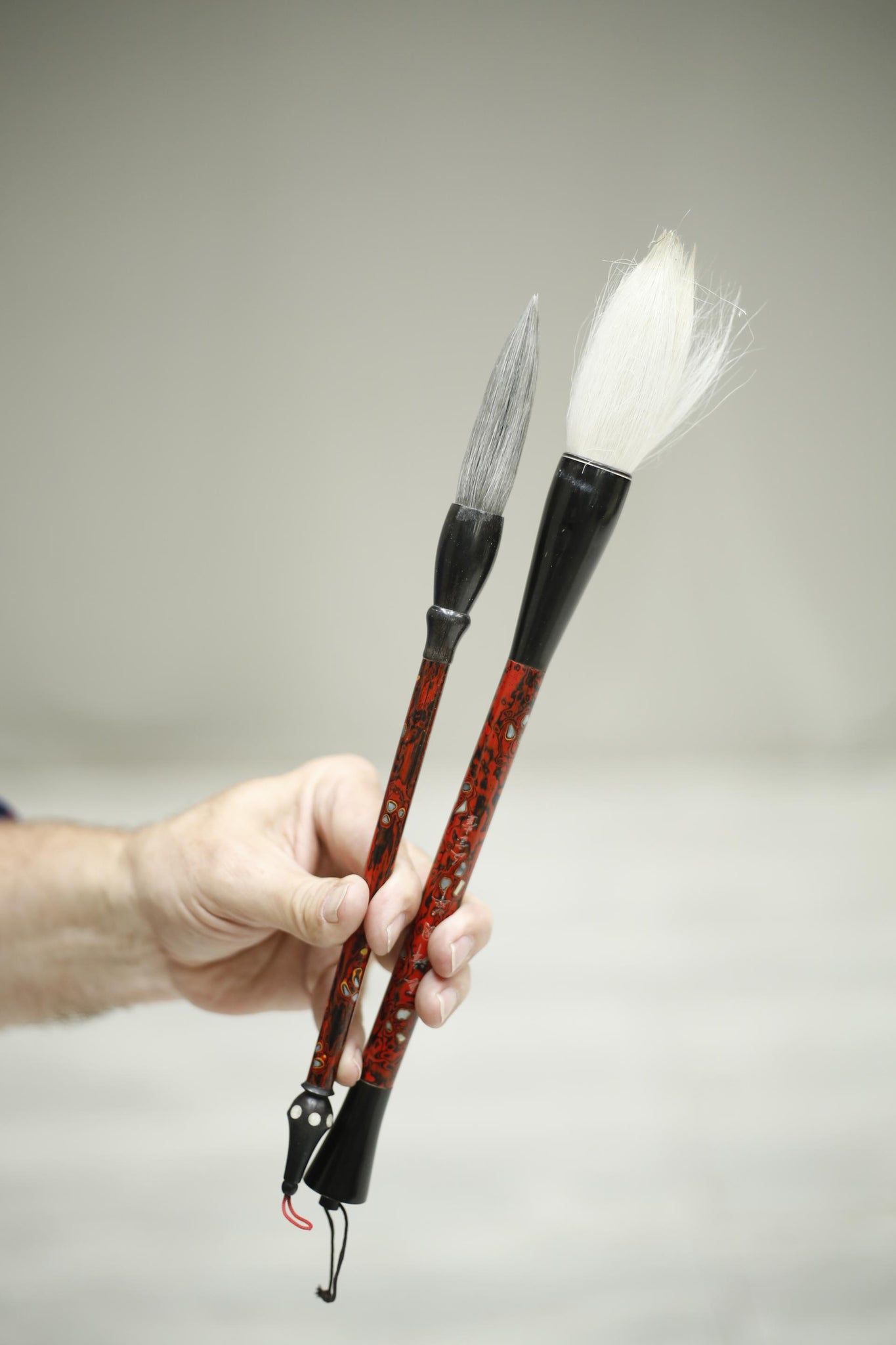 2x 20th century Japanese calligraphy brushes- Red lacquer