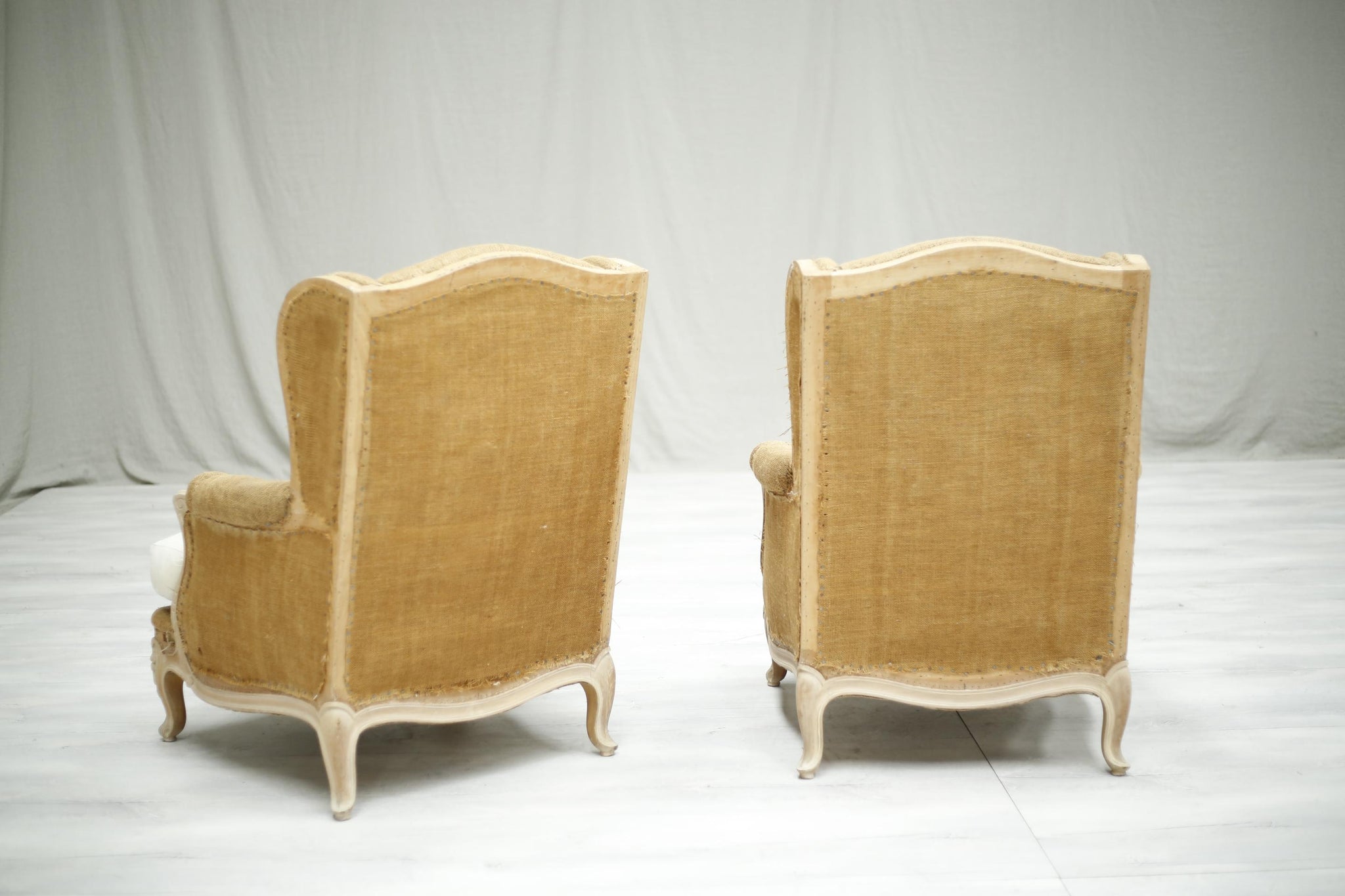 Pair of c.1920 French bleached frame wingback armchairs - TallBoy Interiors