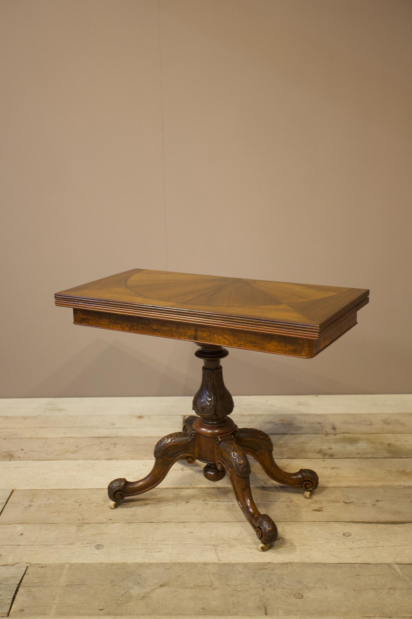 Victorian mahogany fold over table with carved base