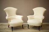 Pair of Napoleon III High backed plain fishtail armchairs