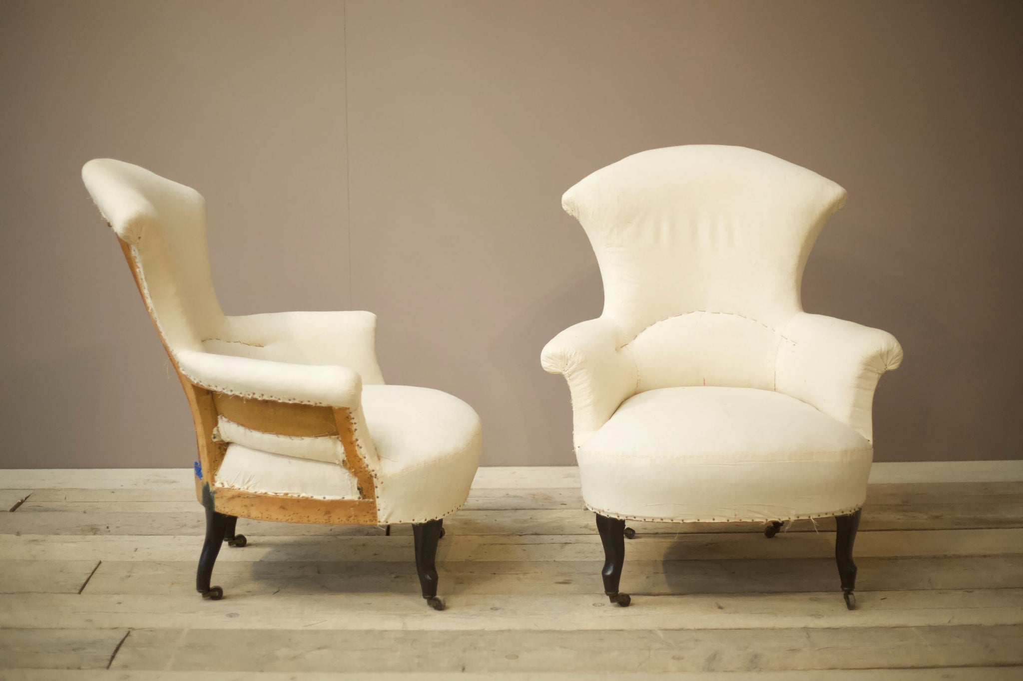 Pair of Napoleon III High backed plain fishtail armchairs