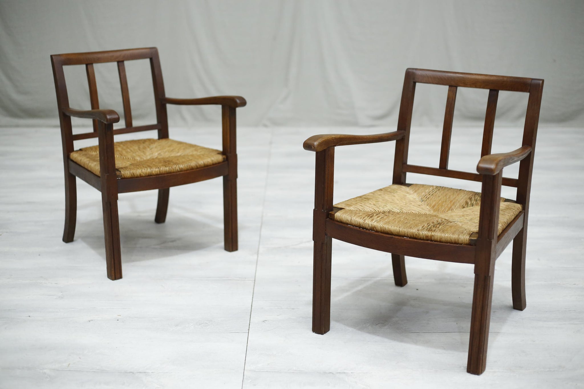 Pair of 1940's Brutalist oak and rush seated lounge chairs