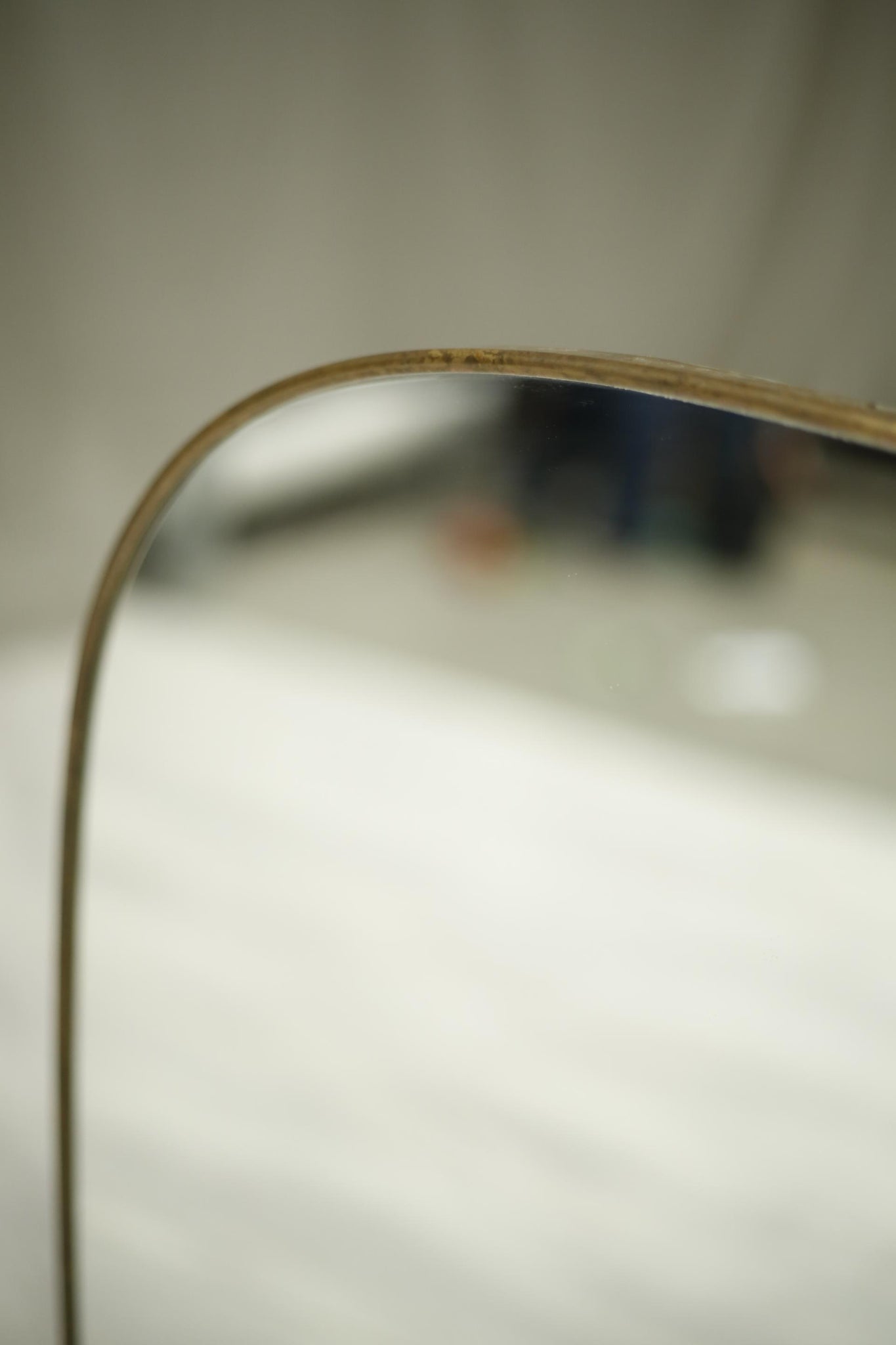 Oval shaped mid century Italian brass edged mirror