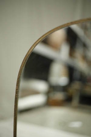 Oval shaped mid century Italian brass edged mirror