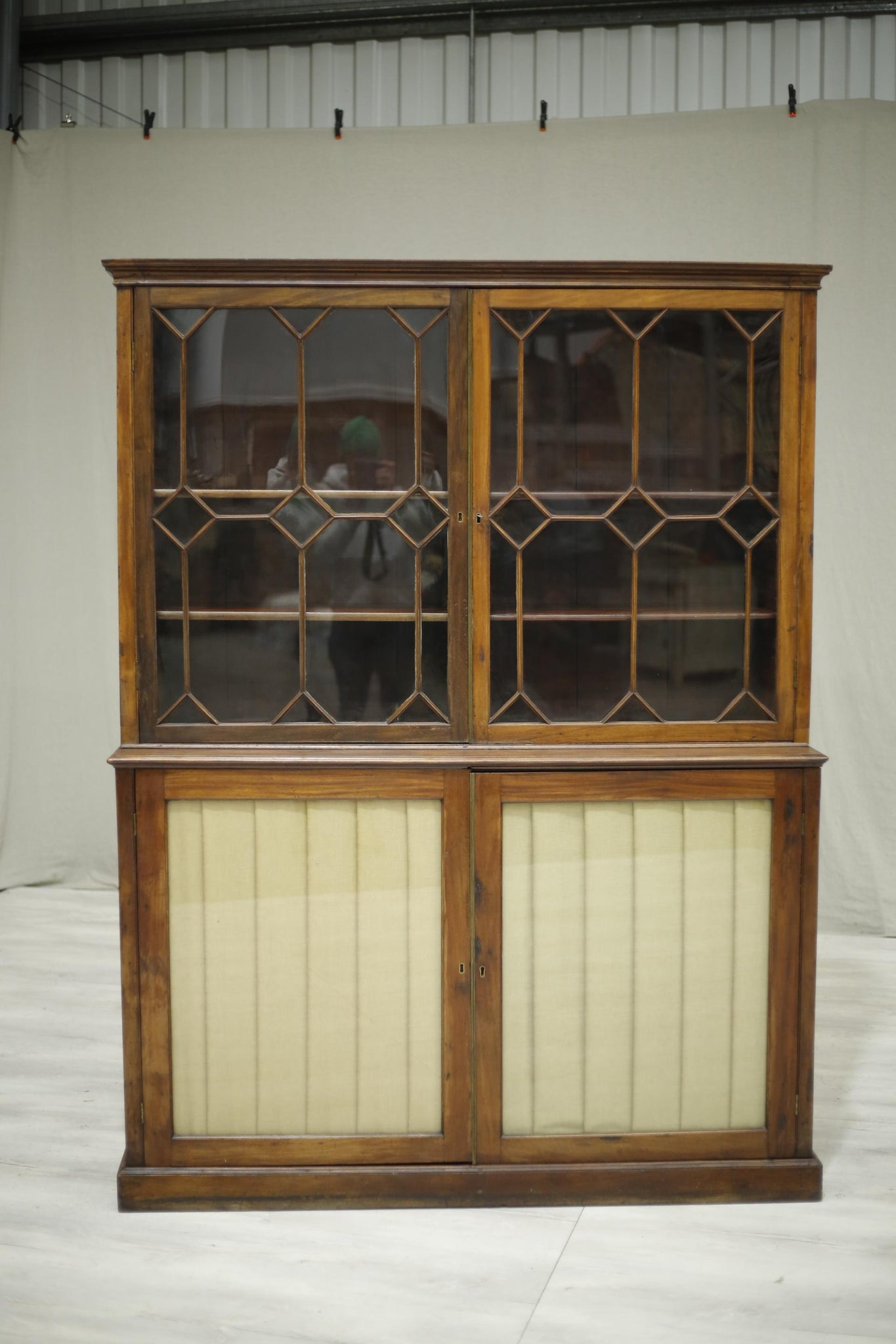 Antique Georgian mahogany glazed cabinet with material doors