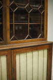 Antique Georgian mahogany glazed cabinet with material doors