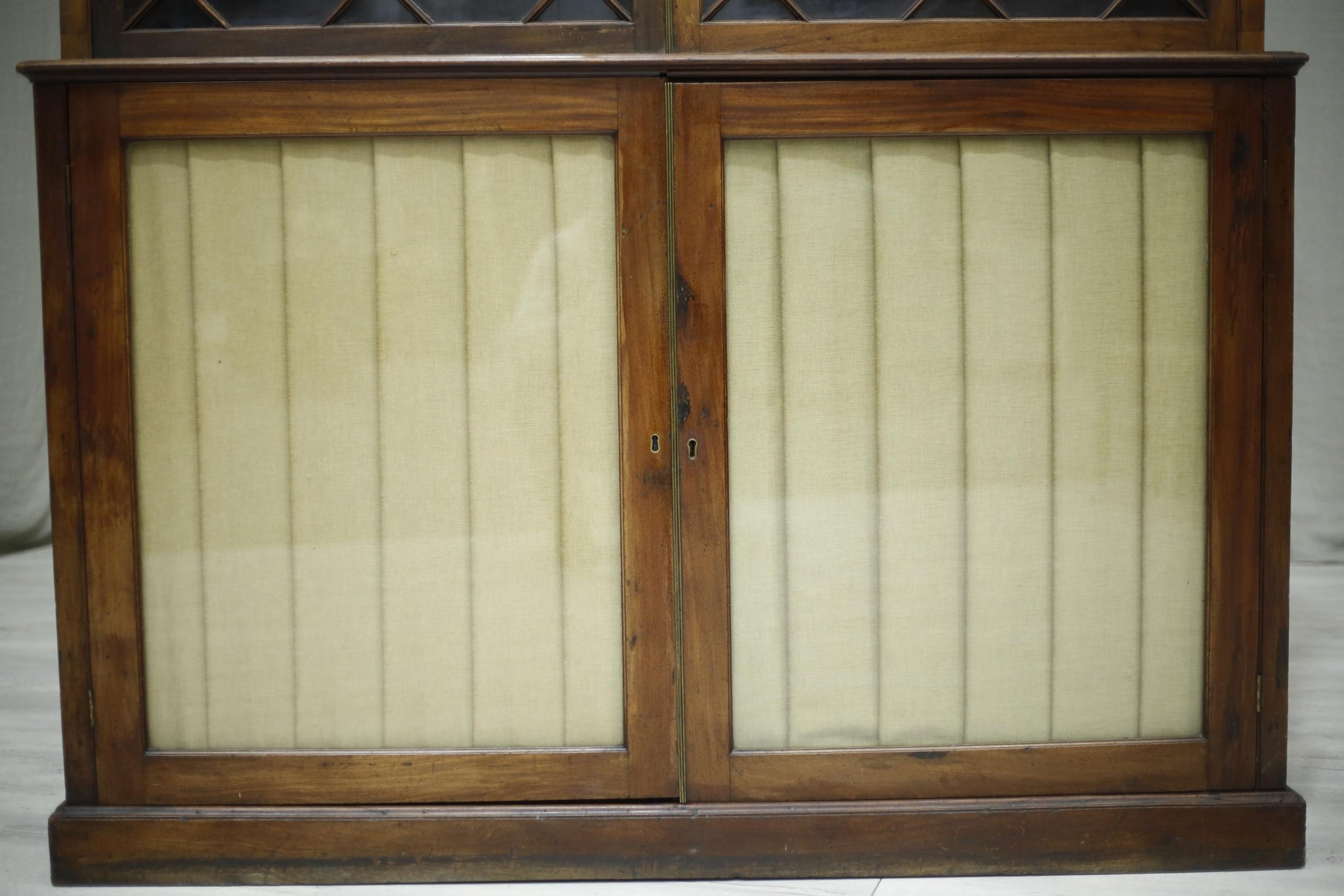 Antique Georgian mahogany glazed cabinet with material doors