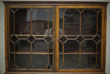 Antique Georgian mahogany glazed cabinet with material doors
