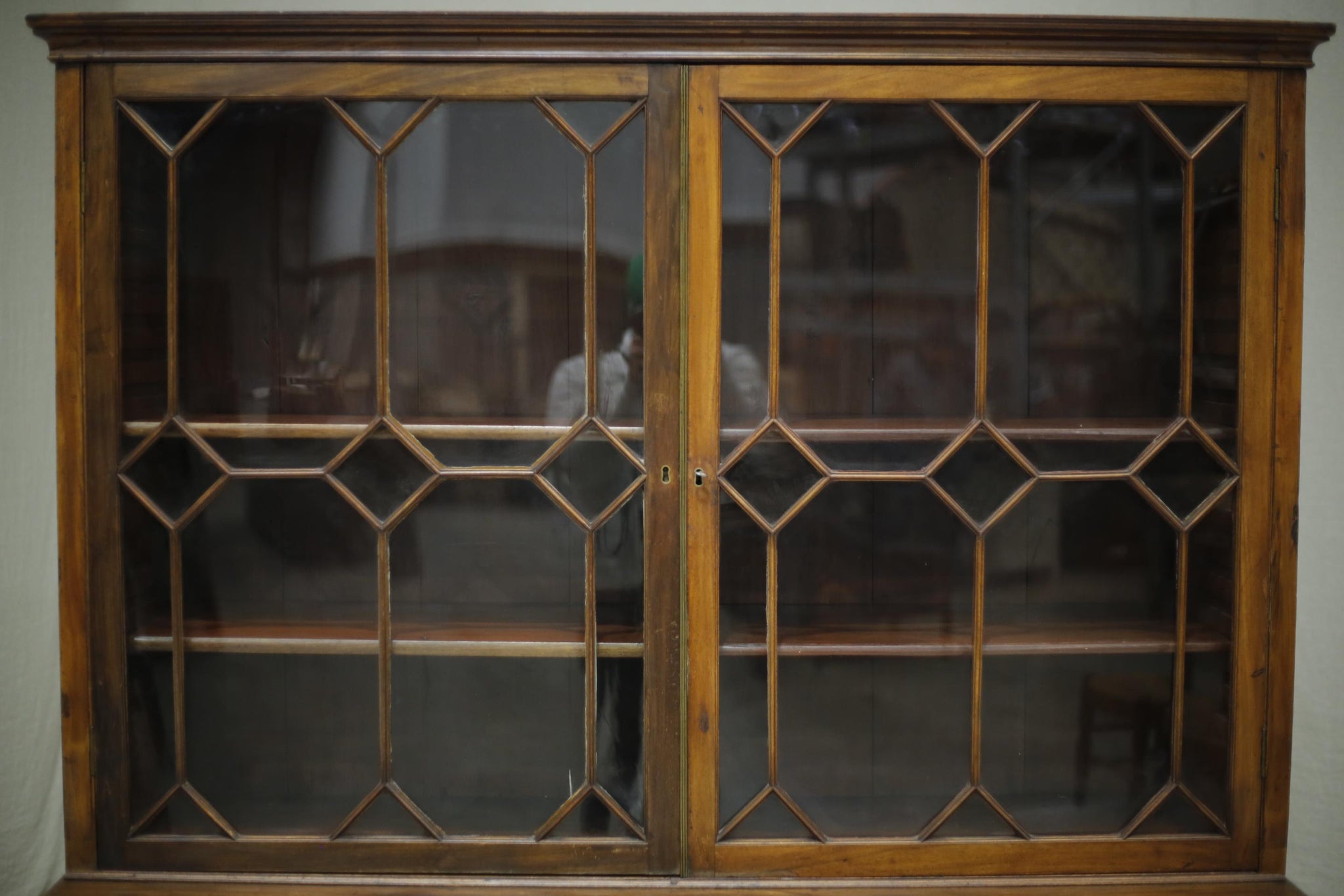 Antique Georgian mahogany glazed cabinet with material doors