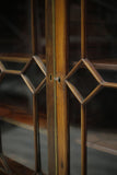 Antique Georgian mahogany glazed cabinet with material doors