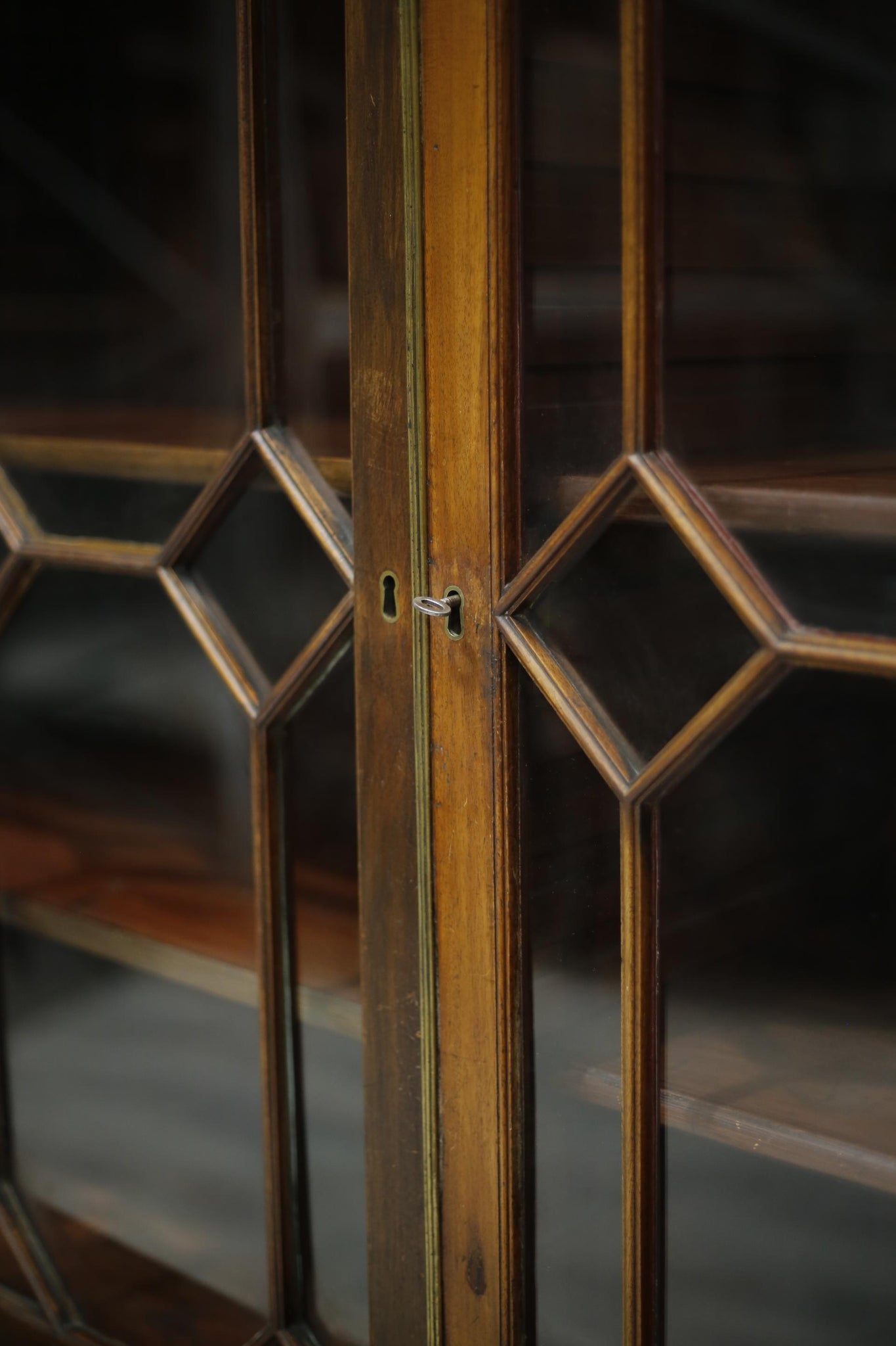 Antique Georgian mahogany glazed cabinet with material doors