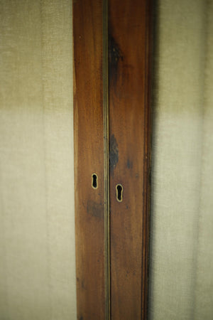Antique Georgian mahogany glazed cabinet with material doors
