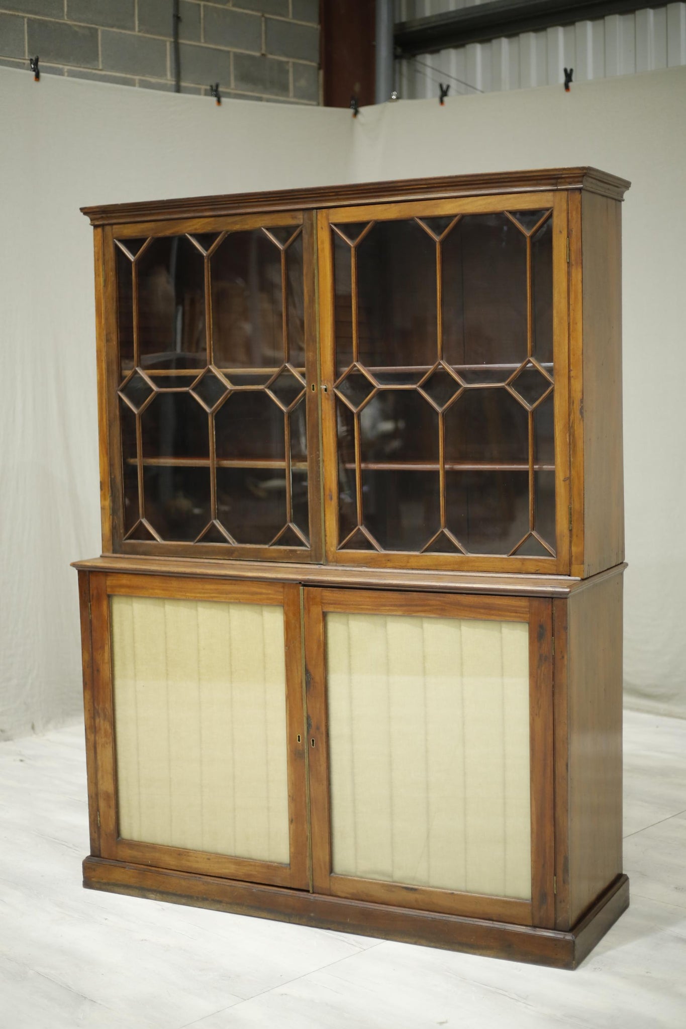 Antique Georgian mahogany glazed cabinet with material doors