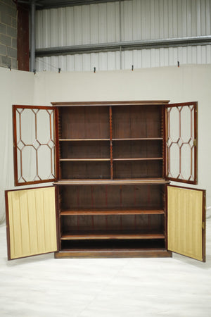 Antique Georgian mahogany glazed cabinet with material doors