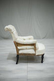 A single Napoleon III Buttoned scroll back armchair