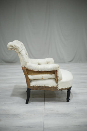 A single Napoleon III Buttoned scroll back armchair