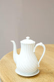 Vintage white porcelain coffee pot with saucer