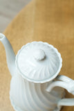 Vintage white porcelain coffee pot with saucer