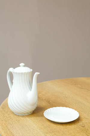 Vintage white porcelain coffee pot with saucer